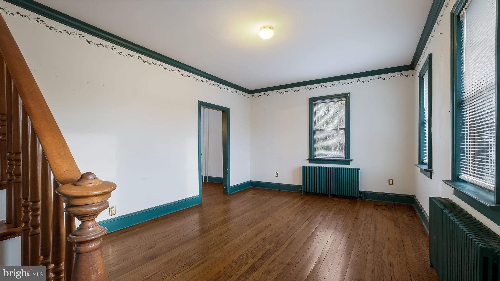 209 Old Bethlehem Road Perkasie, PA 18944 - Photo 13 of 23 a view of an empty room with wooden floor and a window
