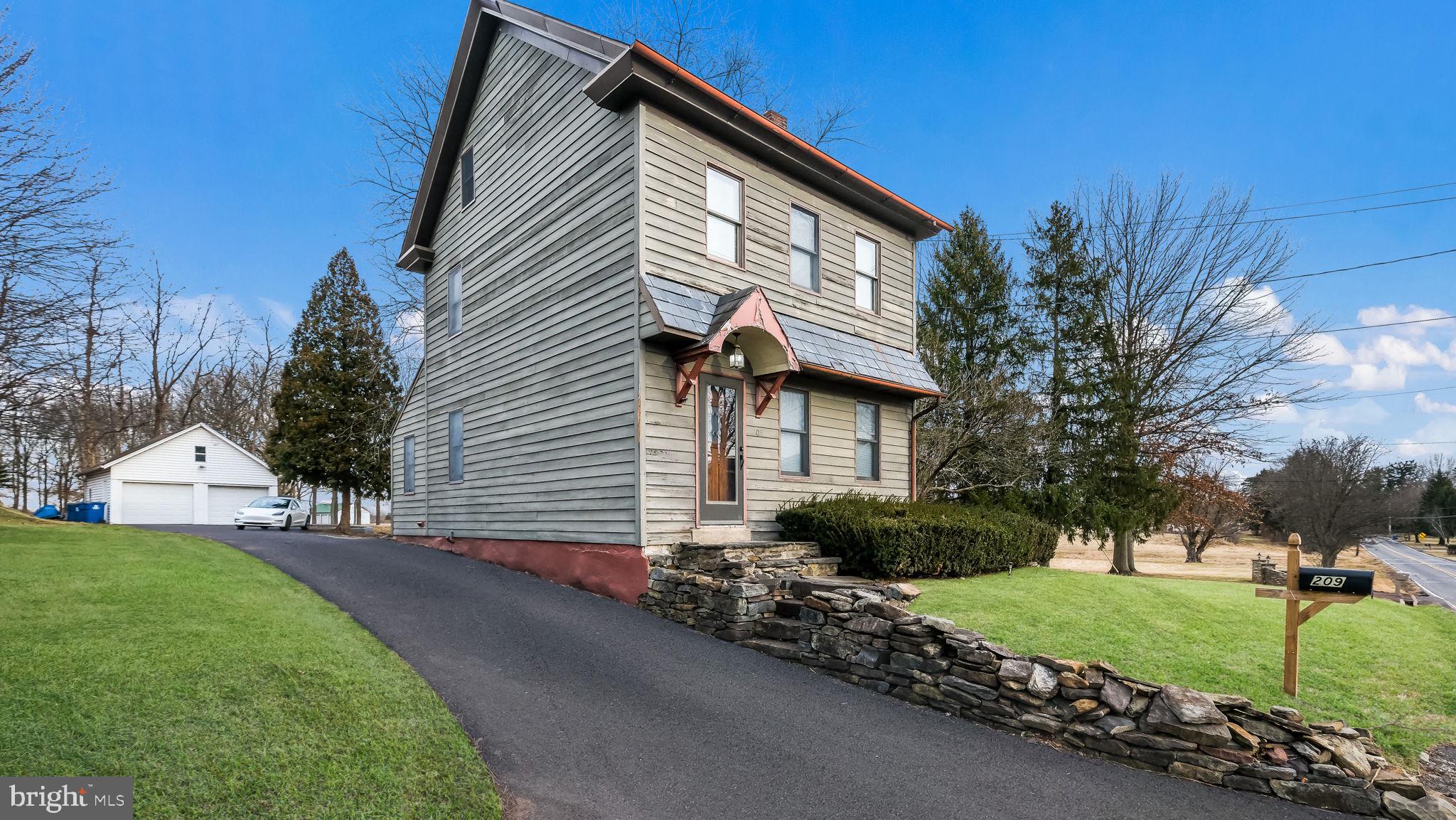 209 Old Bethlehem Road Perkasie, PA 18944 - Photo 2 of 23 a front view of a house with a yard and garage