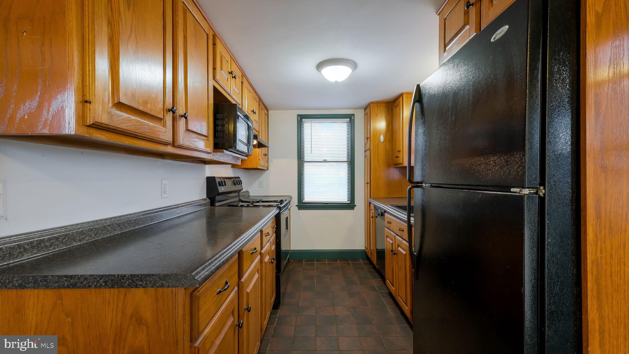 209 Old Bethlehem Road Perkasie, PA 18944 - Photo 7 of 23 a kitchen with a refrigerator and a sink