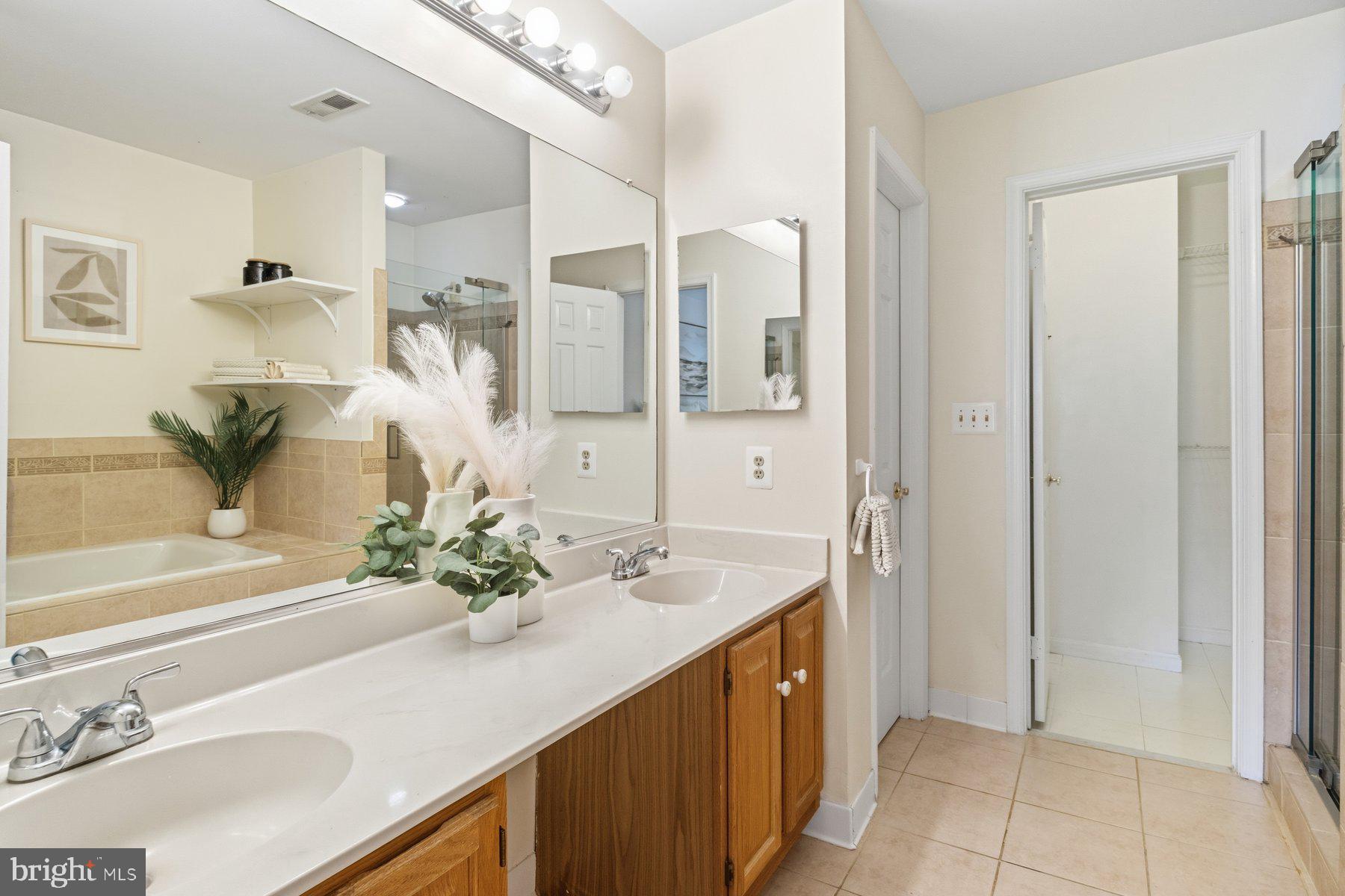 14215 Greenview Drive Laurel, MD 20708 - Photo 20 of 35 a bathroom with a sink and a mirror