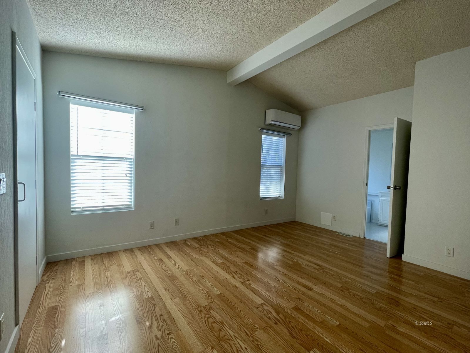 1449 Dunes Street Ridgecrest, CA 93555 - Photo 18 of 50 an empty room with wooden floor and windows