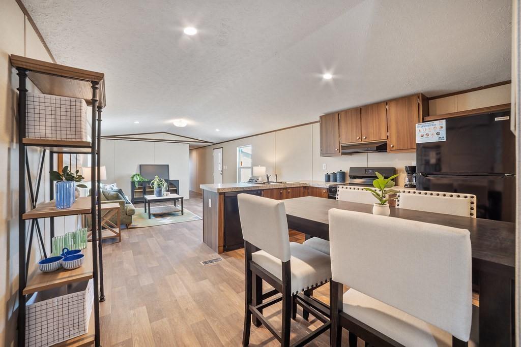 1206 Hayes Road Sherman, TX 75090 - Photo 12 of 21 a living room with furniture a flat tv screen and a bookshelf