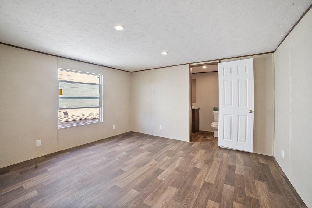 1206 Hayes Road Sherman, TX 75090 - Photo 14 of 21 wooden floor in an empty room with a window