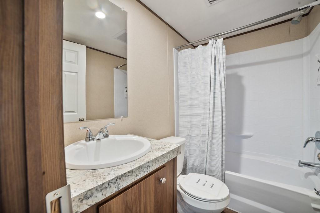 1206 Hayes Road Sherman, TX 75090 - Photo 19 of 21 a bathroom with a granite countertop sink toilet and shower