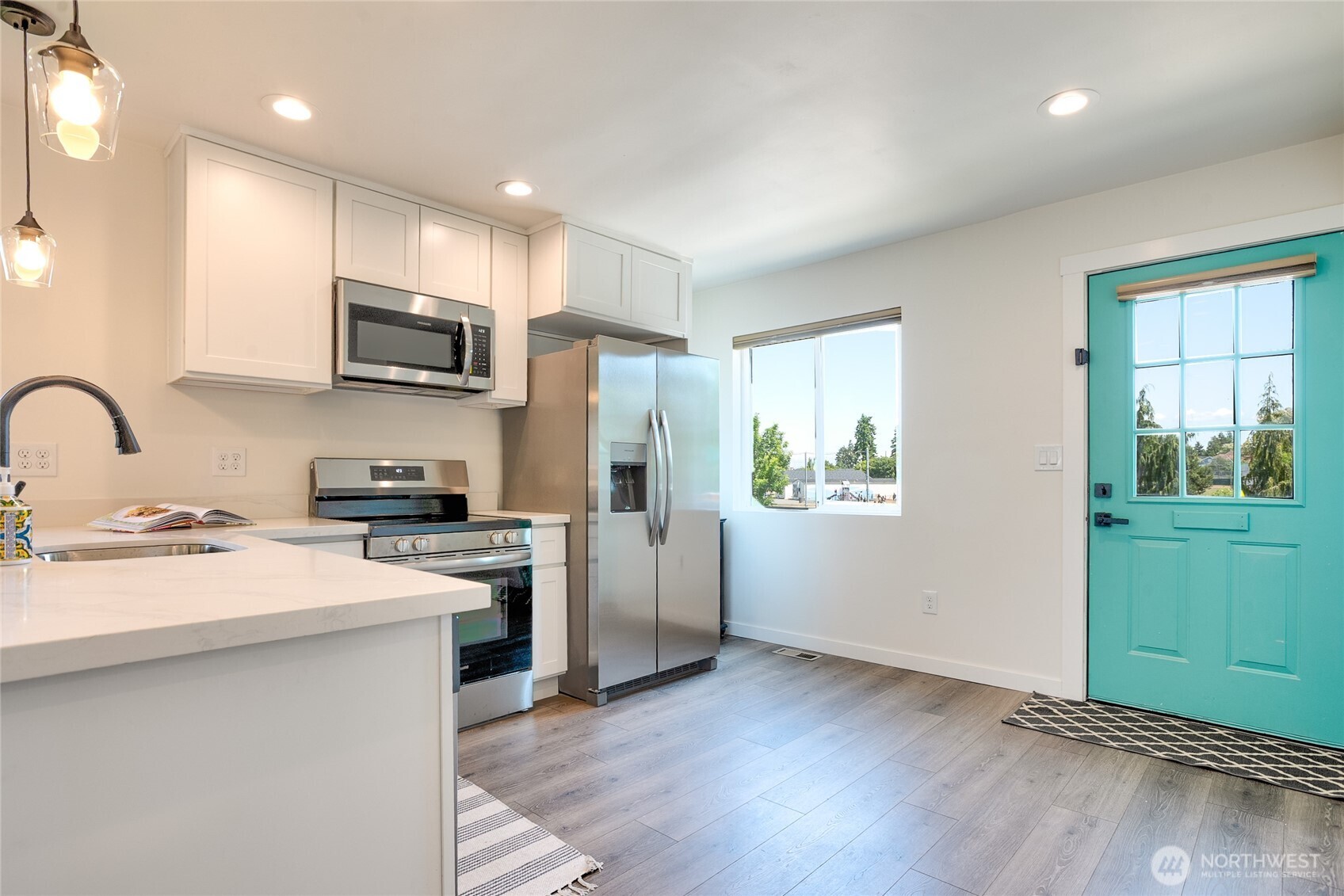 10059 8th Avenue Southwest Seattle, WA 98146 - Photo 5 of 24 a kitchen with kitchen island a sink stainless steel appliances and cabinets