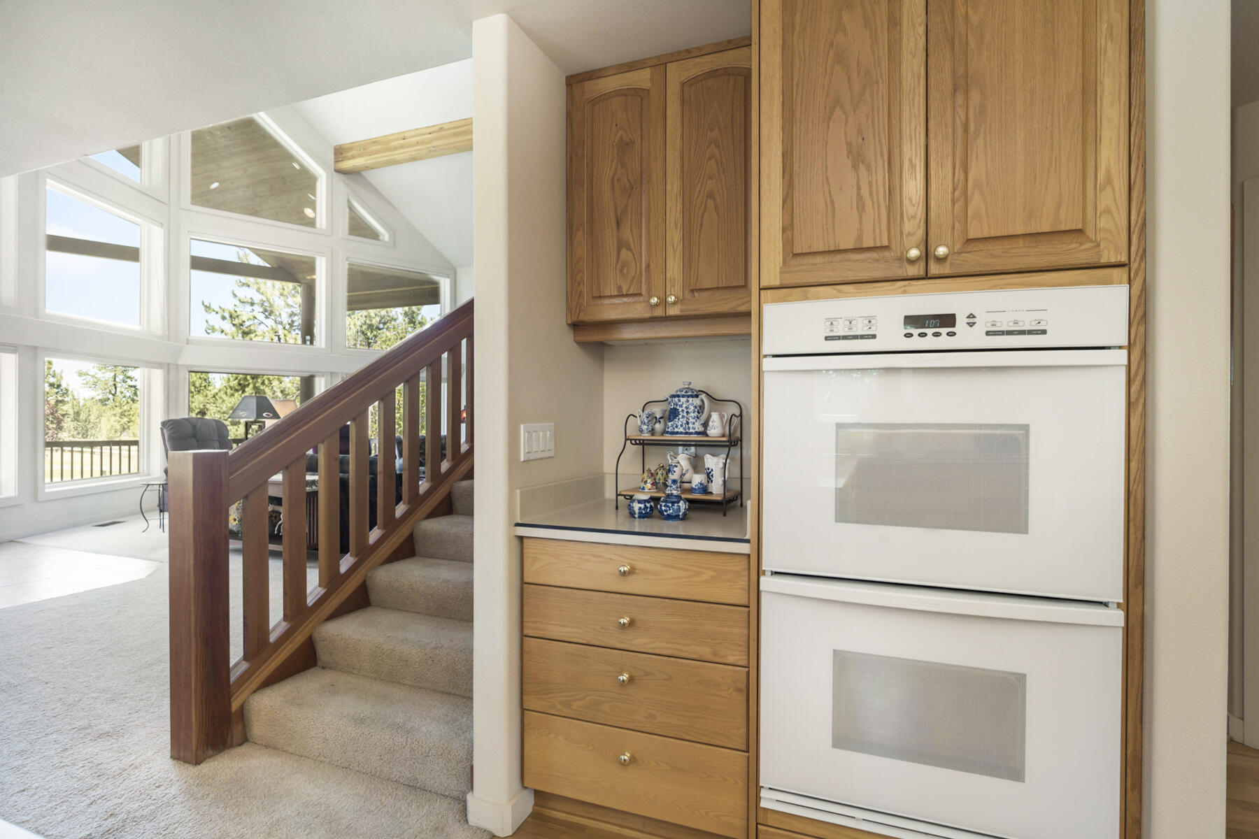 60696 Tekampe Road Bend, OR 97702 - Photo 14 of 61 a kitchen with white cabinets and white appliances