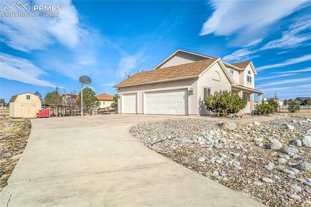 8820 Theriot Road Peyton, CO 80831 - Photo 2 of 50 Desirable South facing driveway and garage means shoveling snow is much less a concern