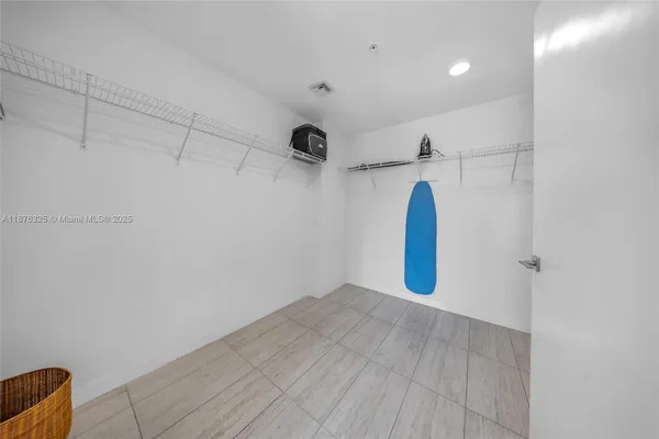 a view of a room with closet and white walls