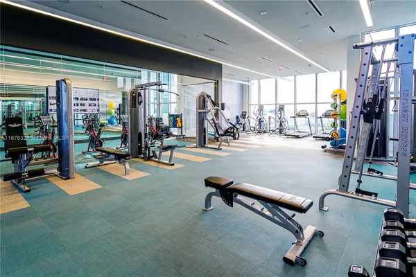 a room with gym equipment and a large window