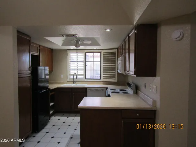 a kitchen with a sink a stove and refrigerator