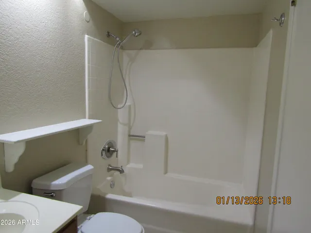 a bathroom with a shower and a toilet