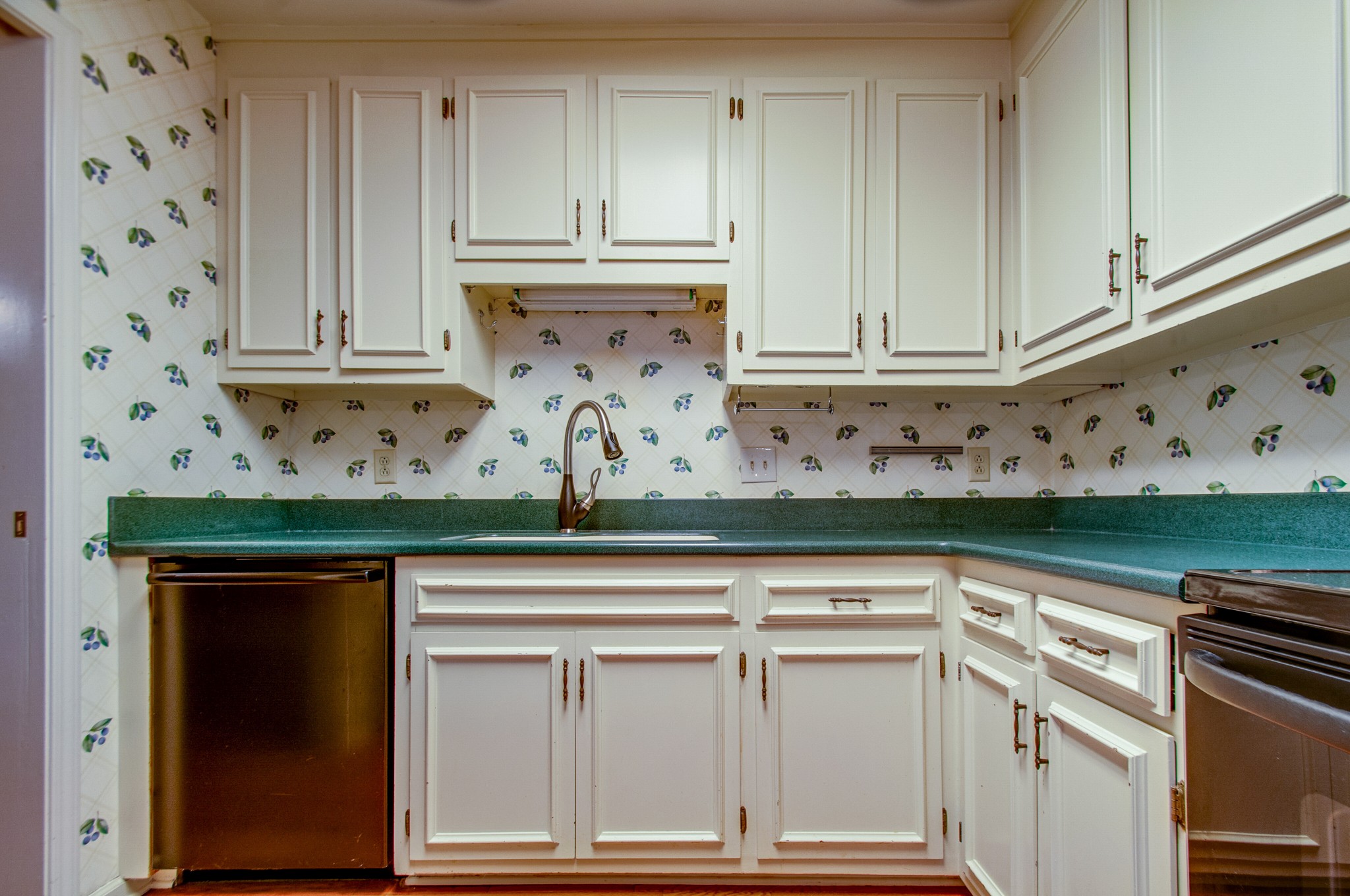 1127 General George Patton Road Nashville, TN 37221 - Photo 11 of 30 a kitchen with granite countertop cabinets and white appliances
