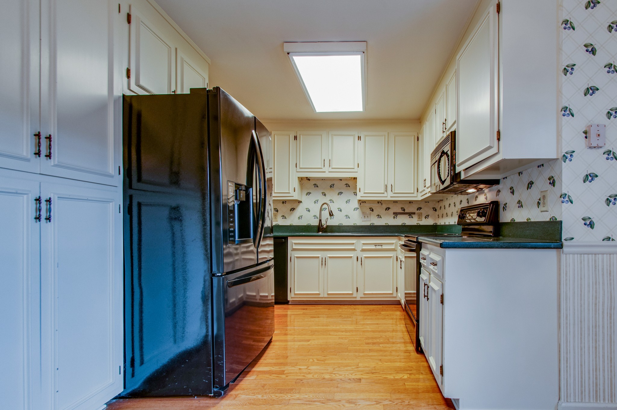 1127 General George Patton Road Nashville, TN 37221 - Photo 12 of 30 a kitchen with stainless steel appliances granite countertop a refrigerator and a sink