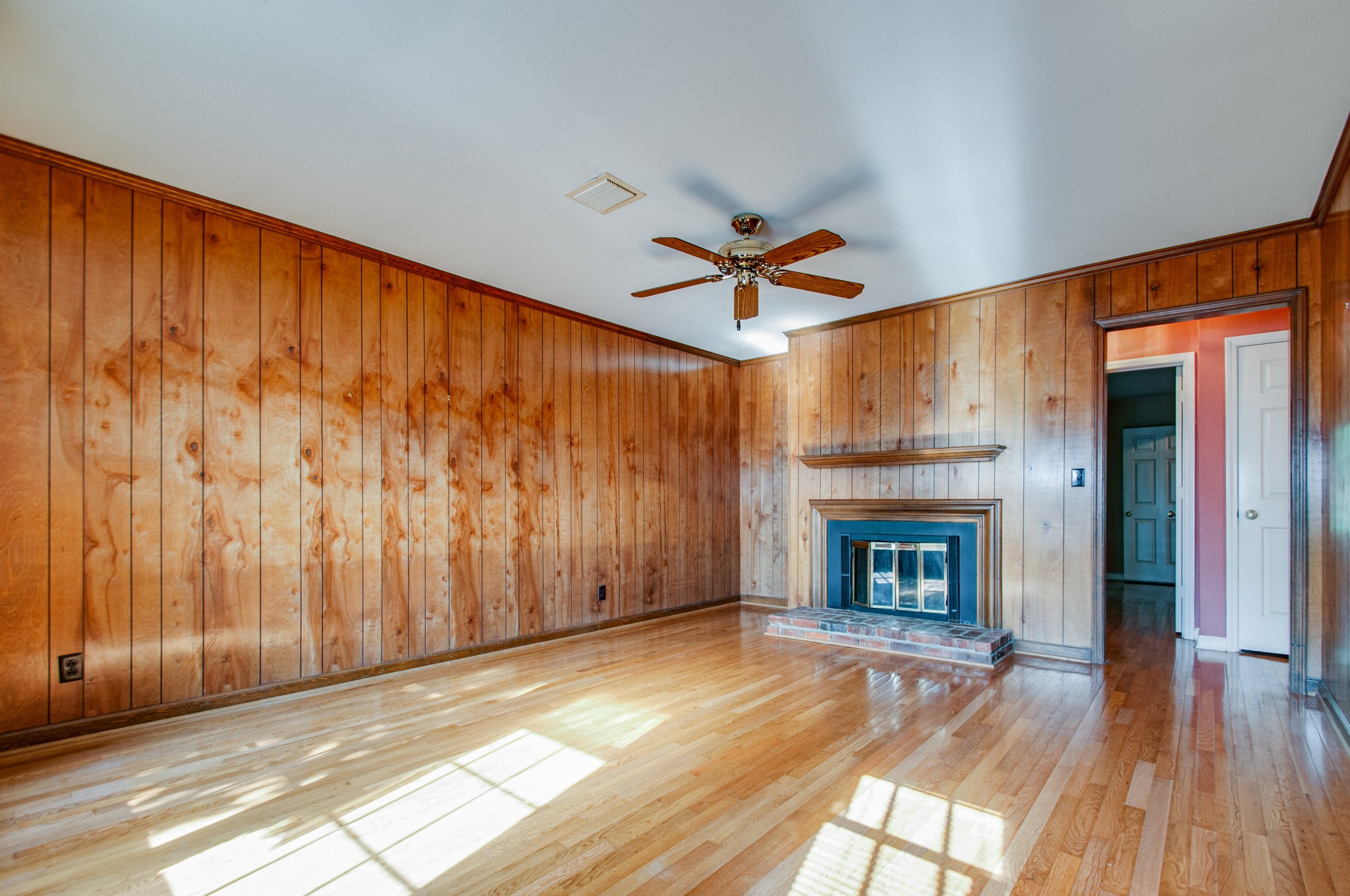 1127 General George Patton Road Nashville, TN 37221 - Photo 17 of 30 wooden floor fireplace and windows in an empty room