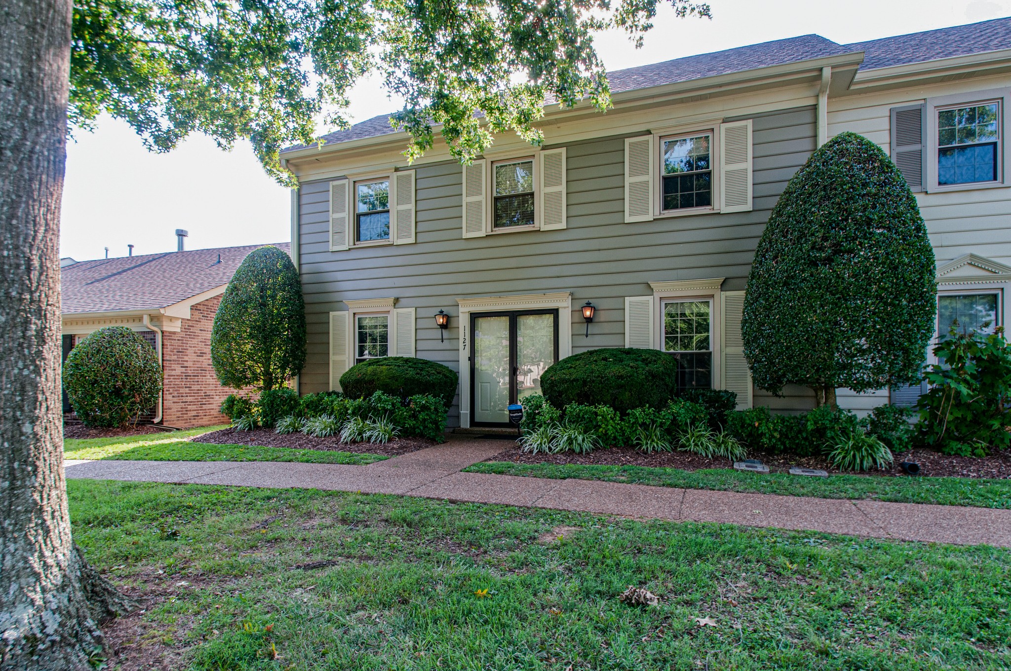 1127 General George Patton Road Nashville, TN 37221 - Photo 3 of 30 a front view of a house with a yard