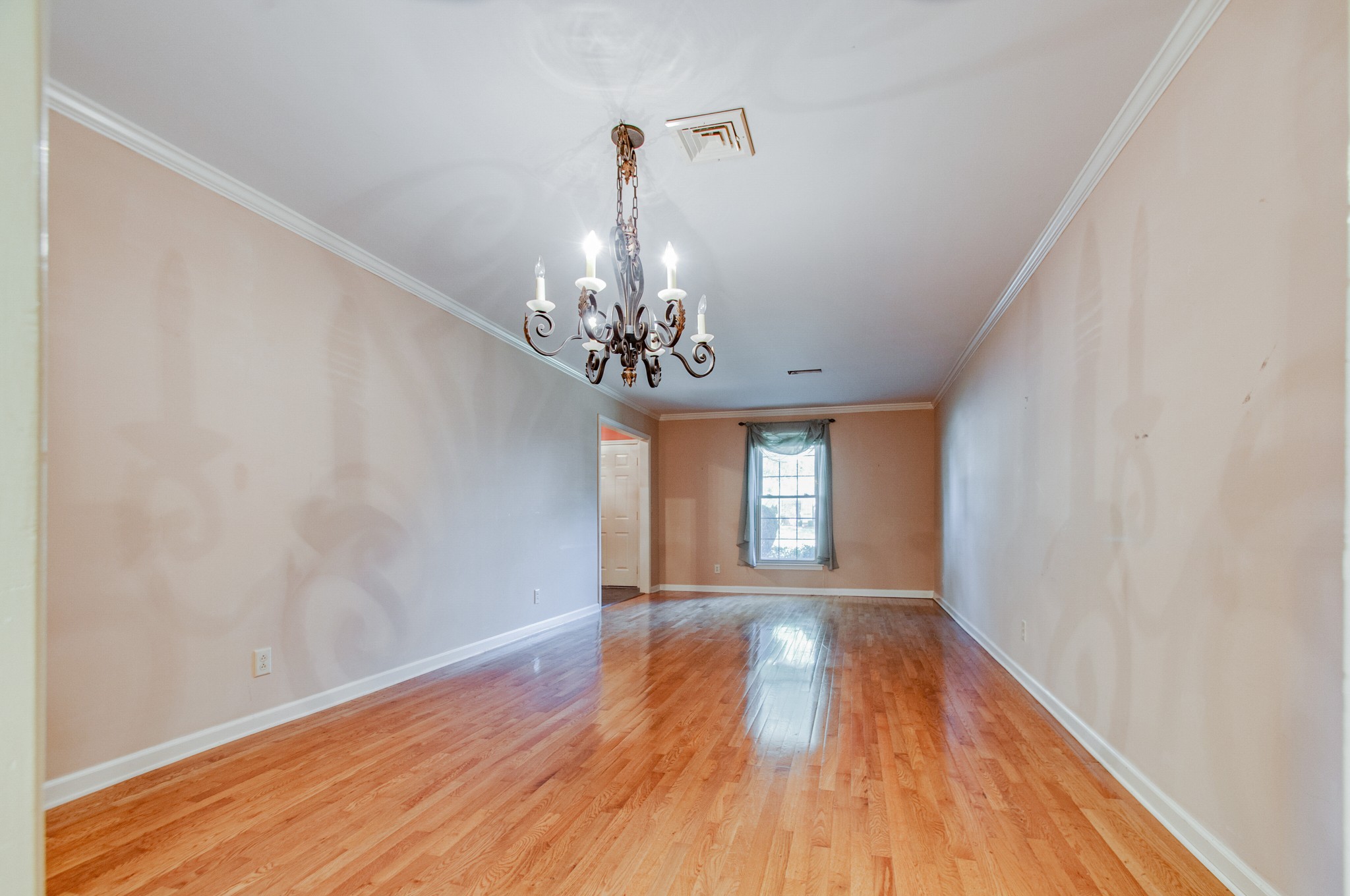 1127 General George Patton Road Nashville, TN 37221 - Photo 6 of 30 a view of a room with wooden floor chandelier and a window