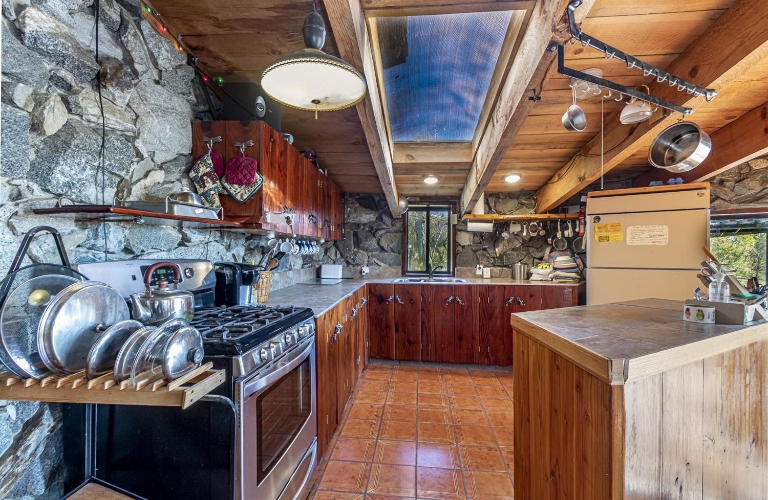 32100 Kinsman Flat Road North Fork, CA 93643 - Photo 14 of 62 a kitchen with stainless steel appliances granite countertop a stove and cabinets