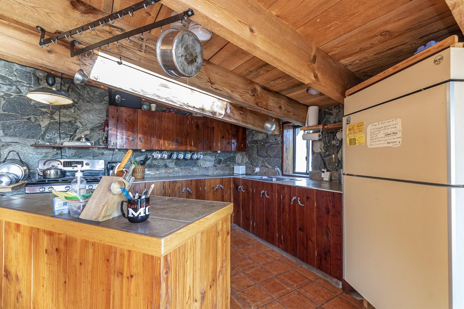 32100 Kinsman Flat Road North Fork, CA 93643 - Photo 15 of 62 a kitchen with a refrigerator and a sink