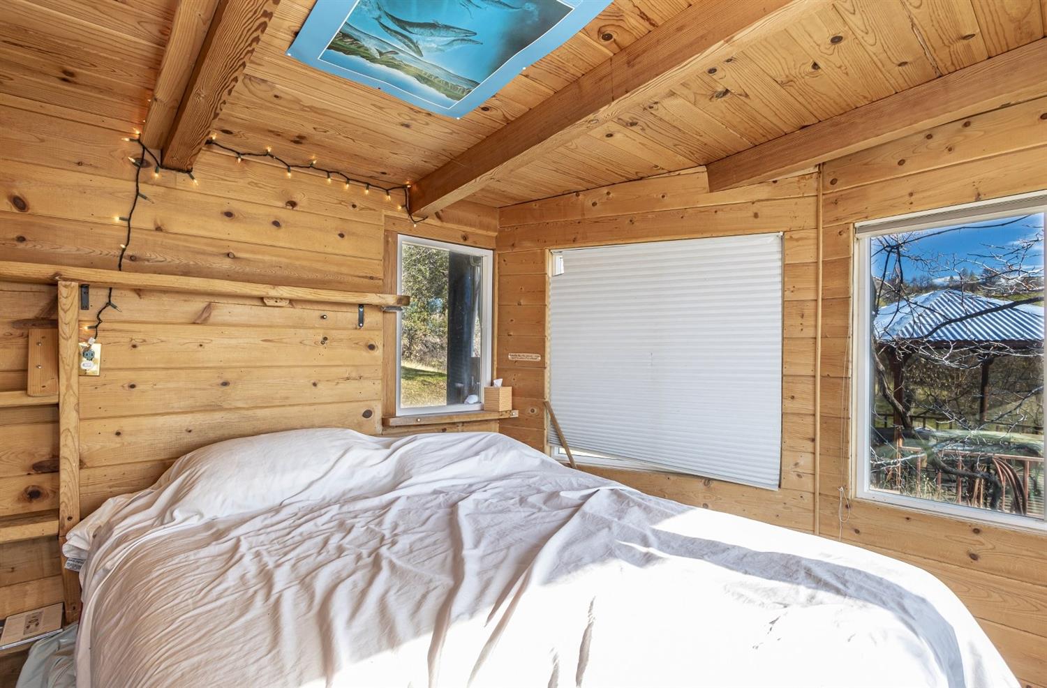 32100 Kinsman Flat Road North Fork, CA 93643 - Photo 19 of 62 a bed sitting in a bedroom next to a window