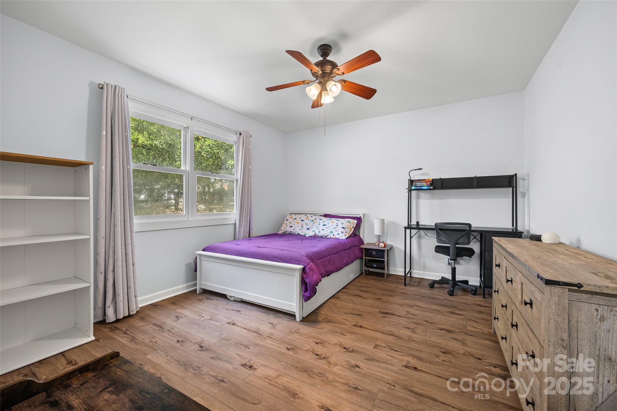 9013 Windjammer Drive Tega Cay, SC 29708 - Photo 12 of 20 a living room with a bed furniture and a window