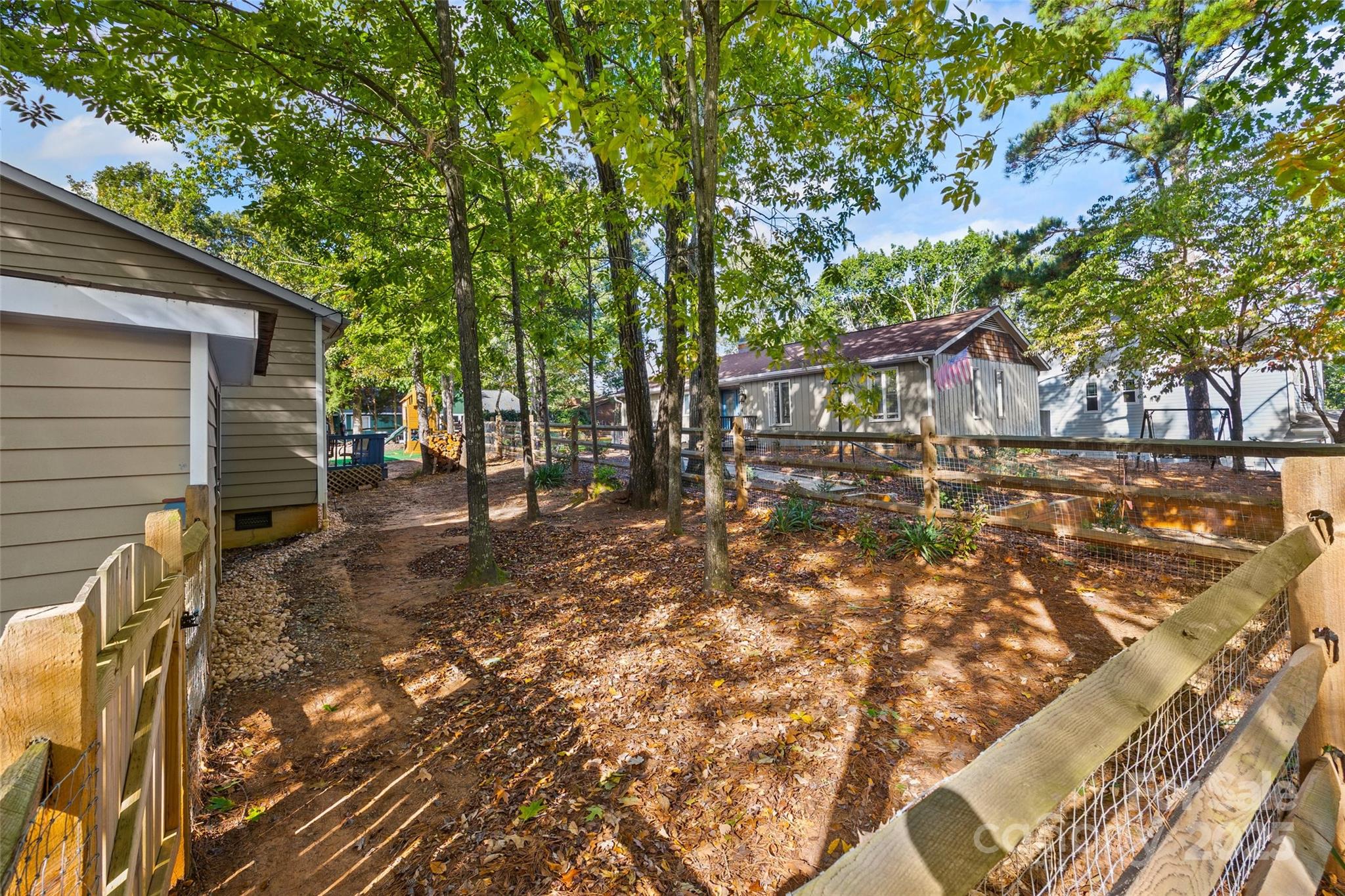 9013 Windjammer Drive Tega Cay, SC 29708 - Photo 16 of 20 a view of a backyard with large trees