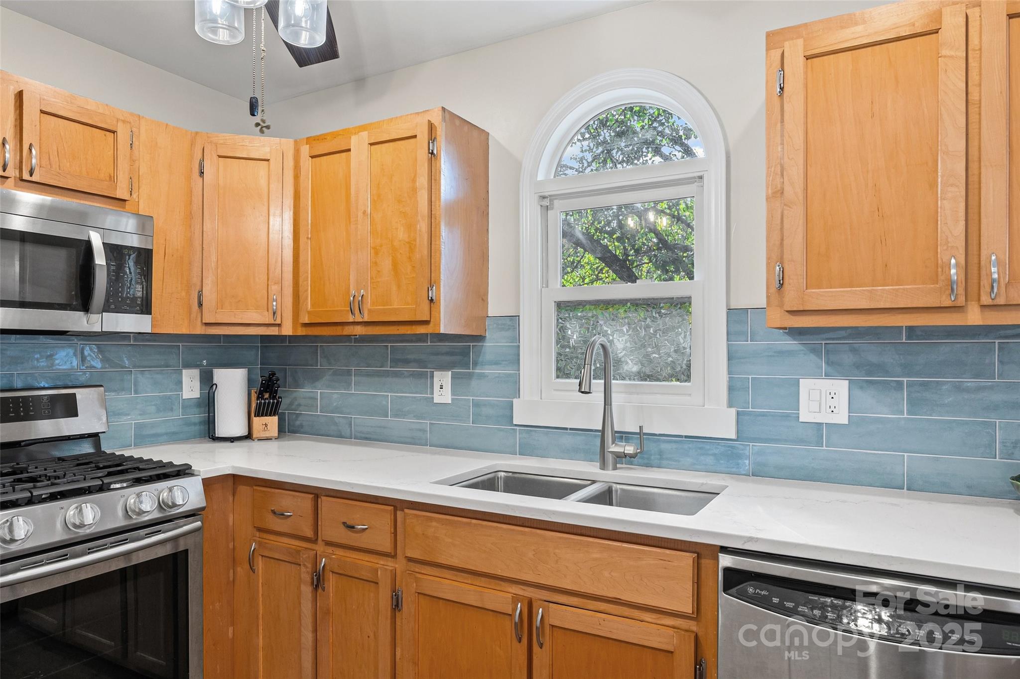 9013 Windjammer Drive Tega Cay, SC 29708 - Photo 8 of 20 a kitchen with stainless steel appliances granite countertop a sink a stove and a microwave