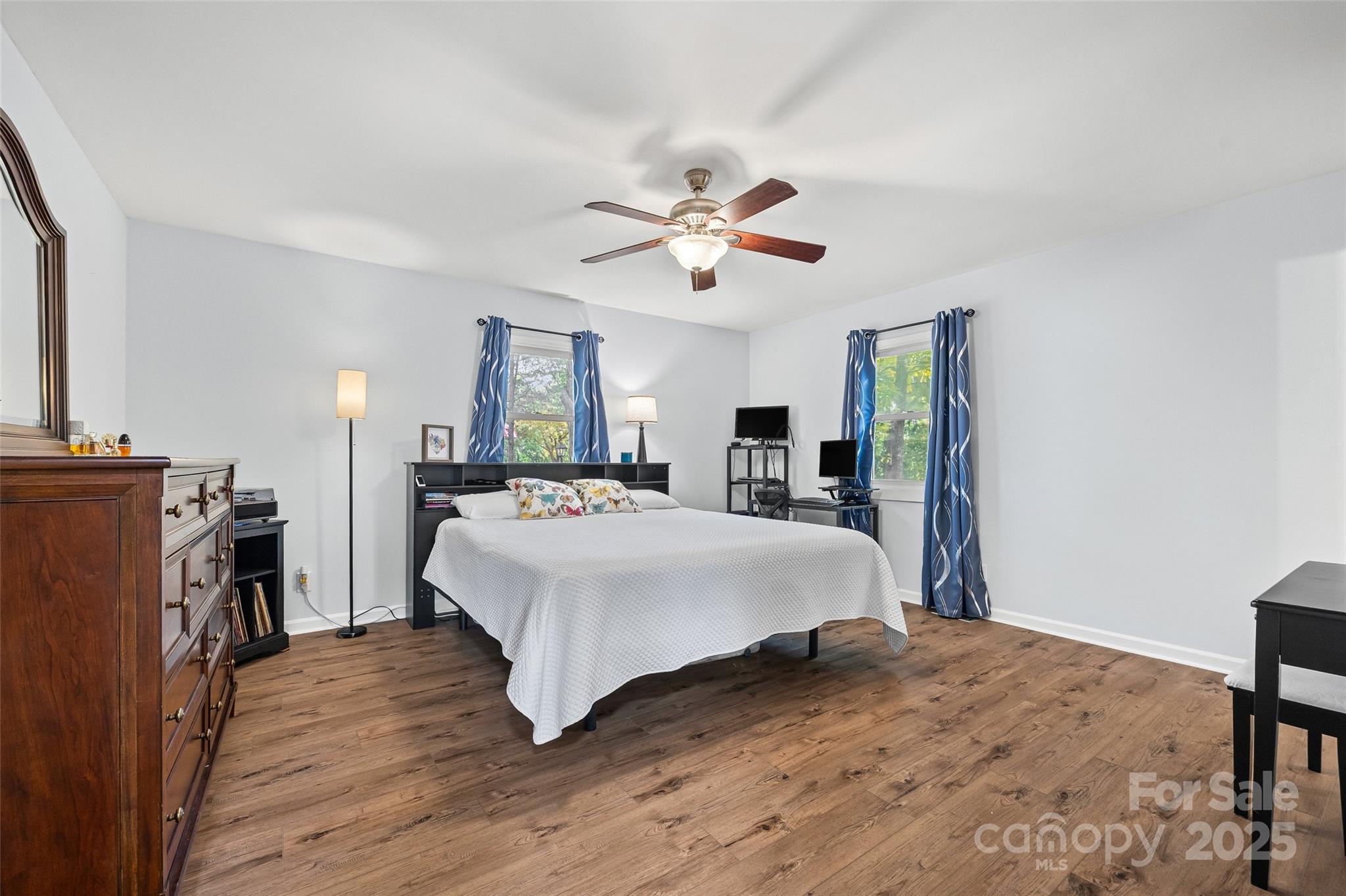 9013 Windjammer Drive Tega Cay, SC 29708 - Photo 10 of 20 a spacious bedroom with a bed and a chandelier