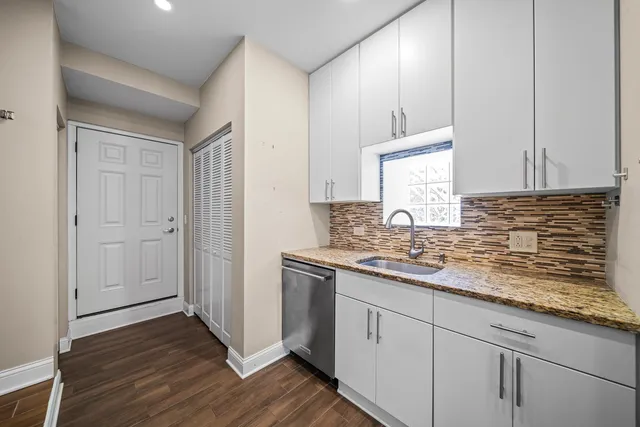 a kitchen with sink cabinets and wooden floor