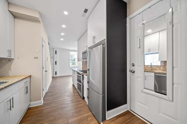 a view of a kitchen with a refrigerator and a stove