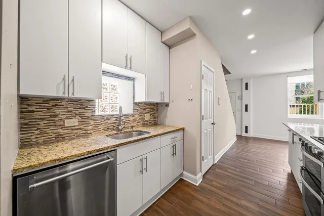 a kitchen with a sink stove and cabinets