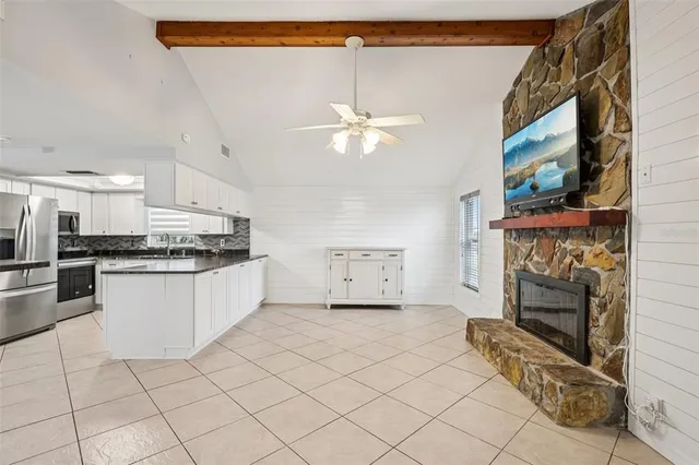 a kitchen with a stove a refrigerator and cabinets