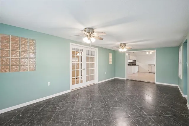 an empty room with windows and closet