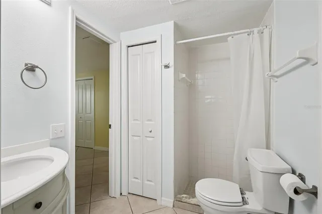 a bathroom with a toilet sink vanity and shower