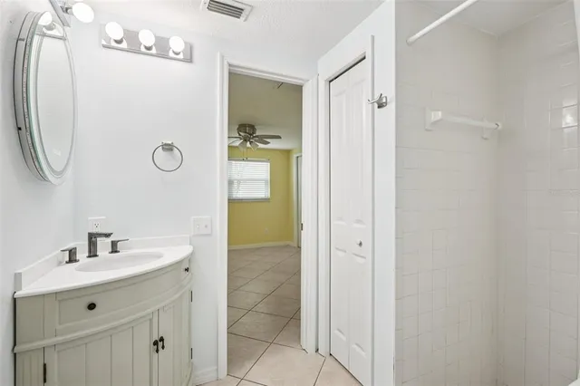 a bathroom with a sink a mirror and a shower