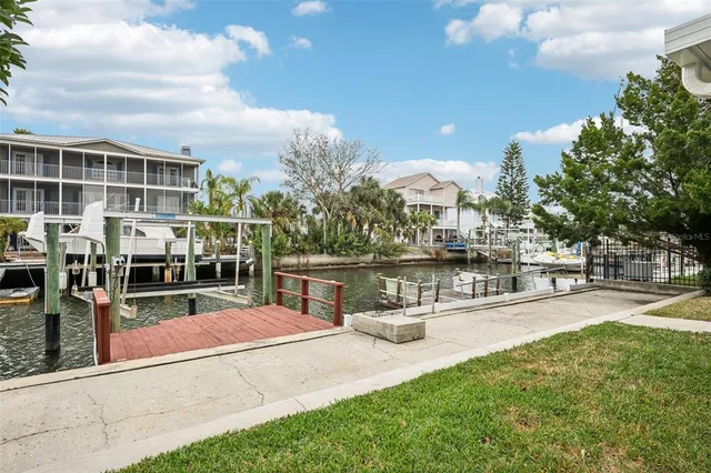 a view of a swimming pool with a patio and couches chairs