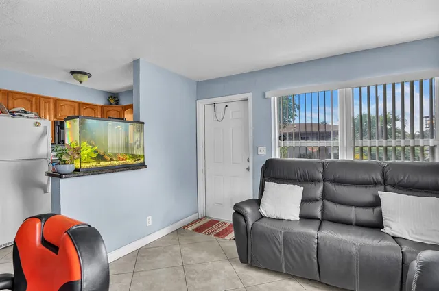a living room with furniture a couch and a window