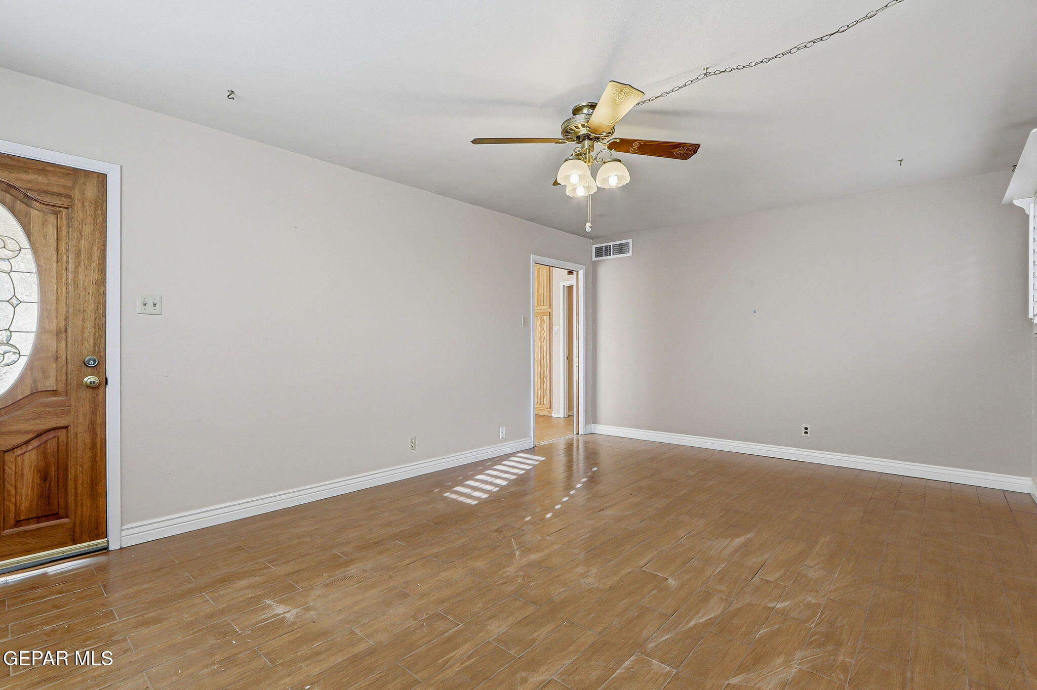 3212 Donegal Road El Paso, TX 79925 - Photo 2 of 37 an empty room with a window and a fan