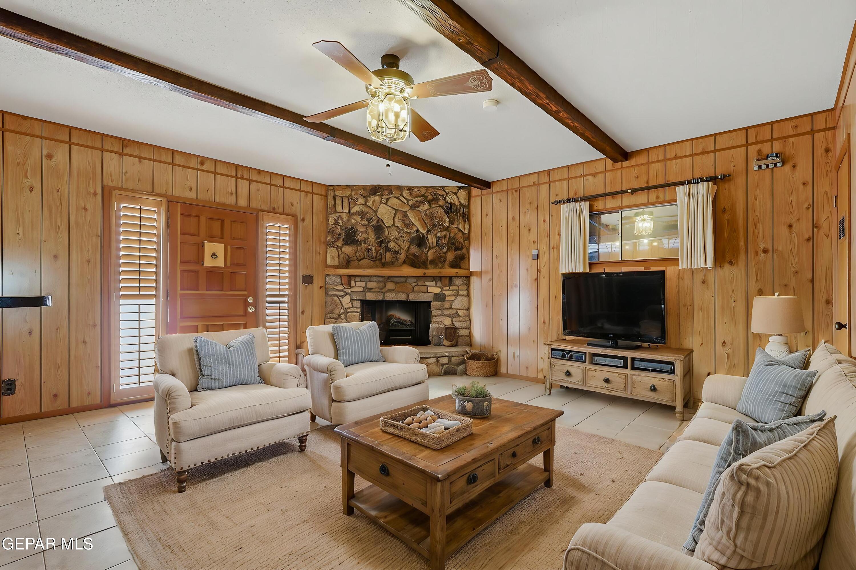 3212 Donegal Road El Paso, TX 79925 - Photo 7 of 40 a living room with furniture a flat screen tv and a large window