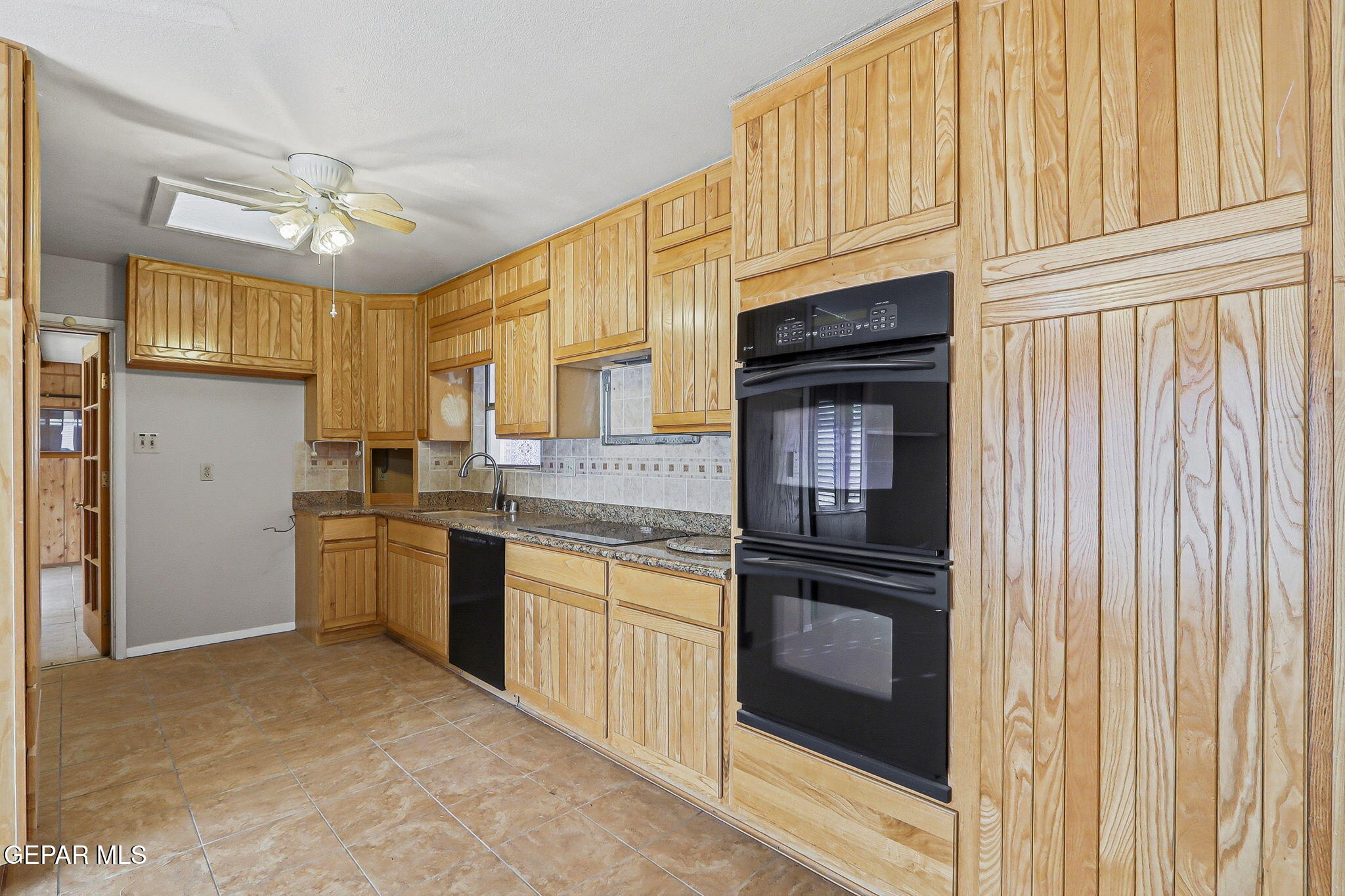 3212 Donegal Road El Paso, TX 79925 - Photo 7 of 37 a kitchen with granite countertop a refrigerator stove and sink