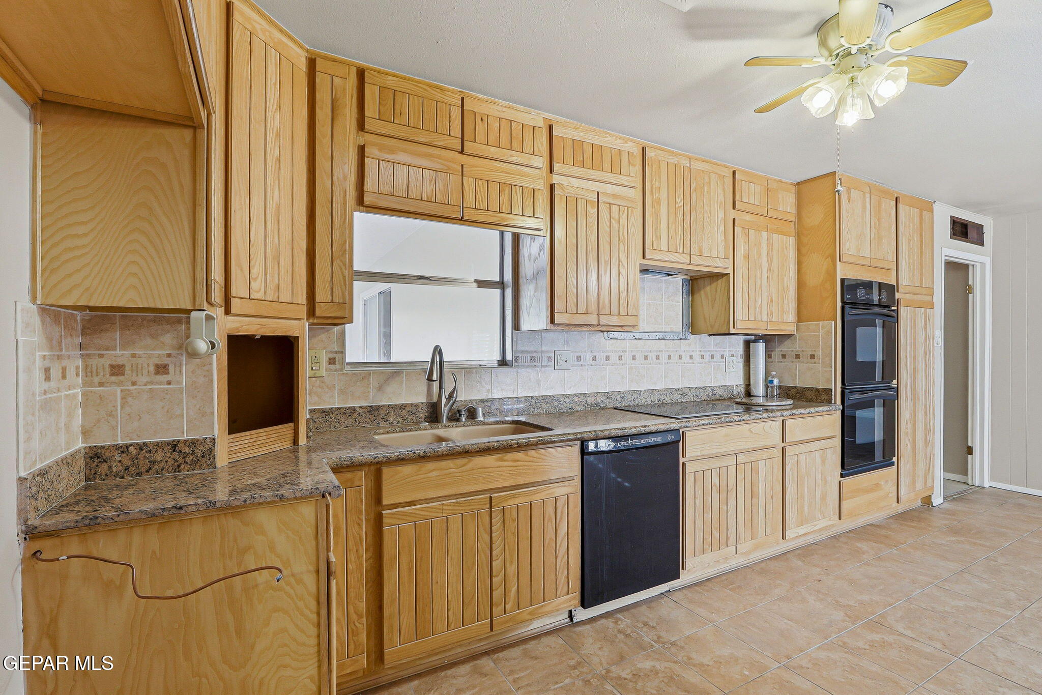 3212 Donegal Road El Paso, TX 79925 - Photo 8 of 37 a kitchen with stainless steel appliances granite countertop a sink stove and refrigerator