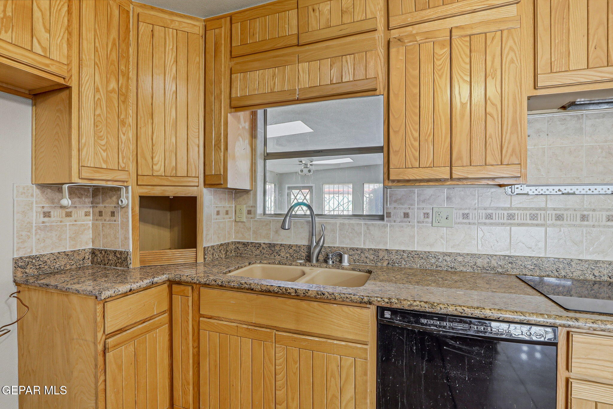 3212 Donegal Road El Paso, TX 79925 - Photo 10 of 37 a kitchen with granite countertop cabinets stainless steel appliances a sink and a window