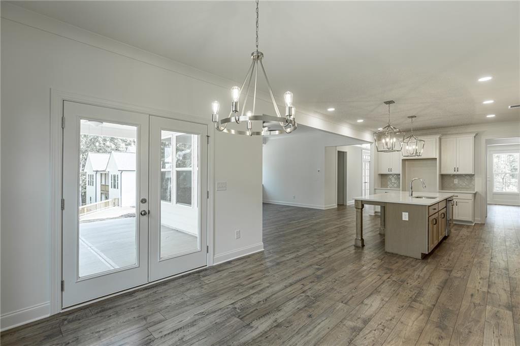 1210 Austin Road Winder, GA 30680 - Photo 20 of 56 a large kitchen with a refrigerator a sink dishwasher a dining table and chairs