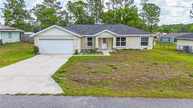 a front view of a house with yard