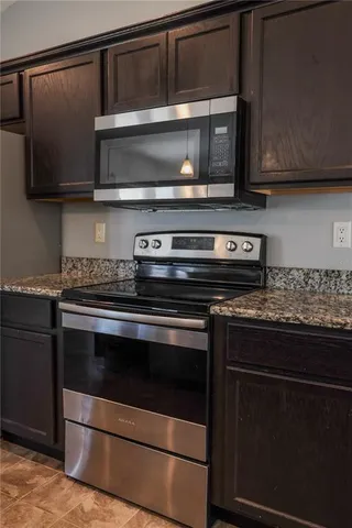 a stove top oven sitting inside of a kitchen
