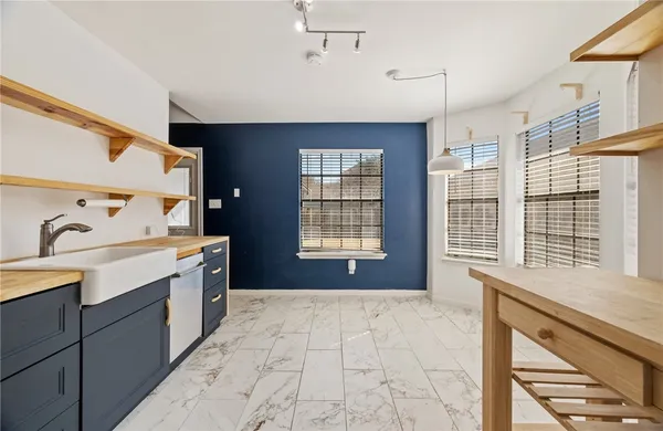 a spacious bathroom with a granite countertop sink a large mirror and a bathtub with shower