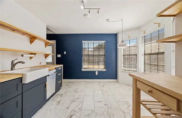 a spacious bathroom with a granite countertop sink a large mirror and a bathtub with shower