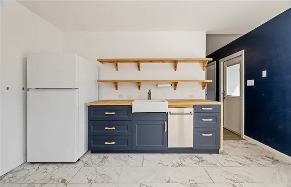 a kitchen with stainless steel appliances a refrigerator and cabinets