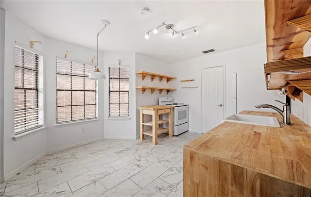a spacious bedroom with a bed and a window