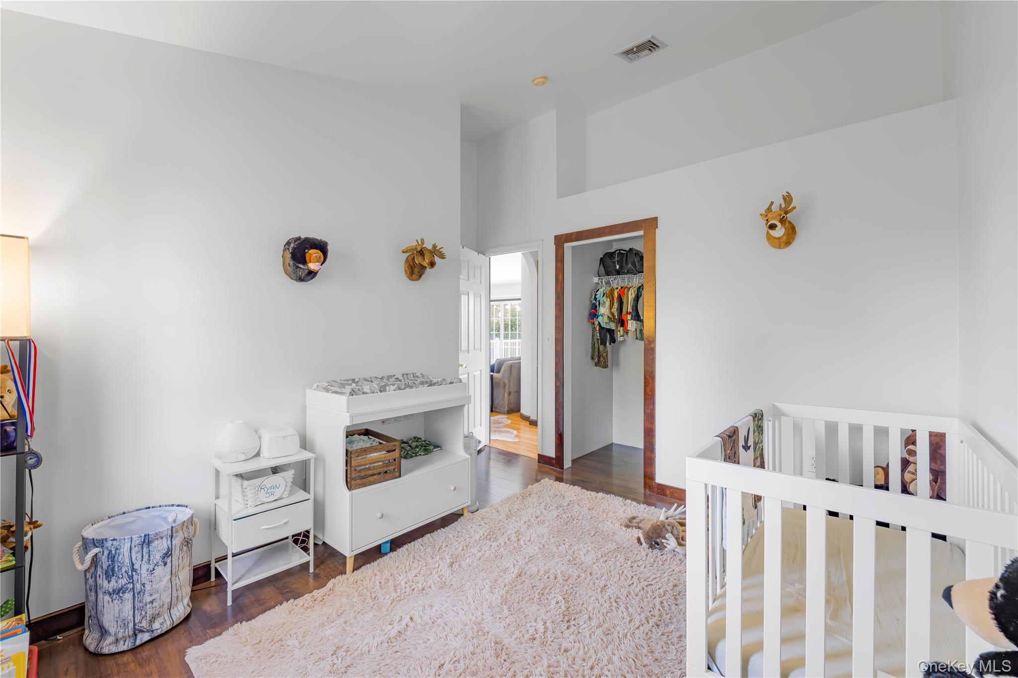 17 Brendella Court Wallkill, NY 12589 - Photo 19 of 42 Bedroom with a crib, dark wood-style flooring, and a closet