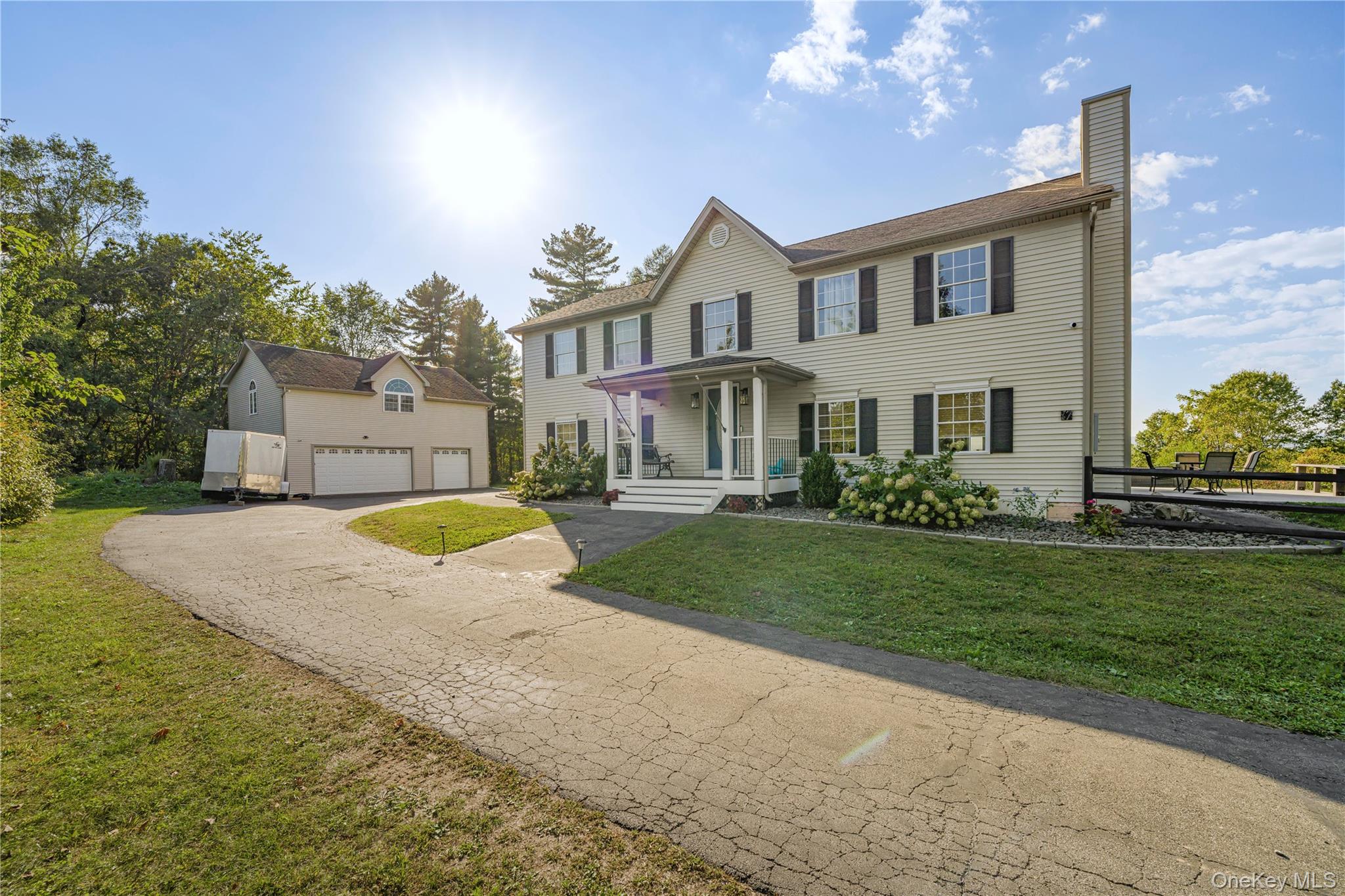17 Brendella Court Wallkill, NY 12589 - Photo 2 of 42 Colonial home with a garage, a chimney, a front lawn, asphalt driveway, and covered porch
